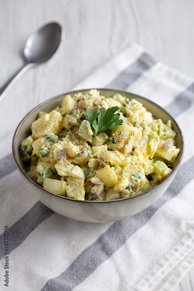 Homemade Potato Egg Salad with Pickles in a Bowl, side view. Homemade Potato Egg Salad with Pickles in a Bowl, side view.