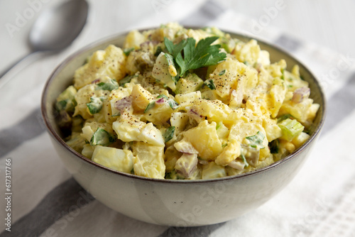 Homemade Potato Egg Salad with Pickles in a Bowl, side view.