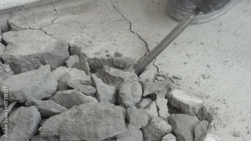 The jackhammer breaks the cement screed. Work with a perforator. A close-up of the perforator chisel. Under construction. Knocking down excess concrete in the apartment. High quality 4k footage