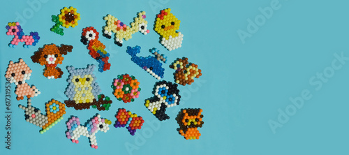 figurines made of beads. cute children's crafts. handmade work. small toys. design background