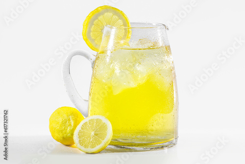 glass of lemonade with lemons in a white background