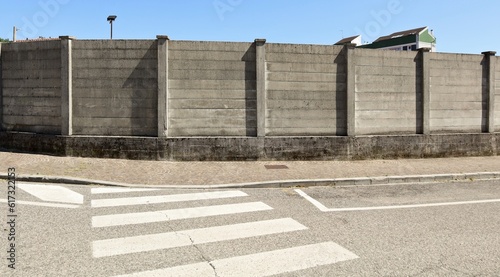 Wallpaper Mural Large concrete surrounding wall with sidewalk and crosswalk in front. Background for copy space. Torontodigital.ca