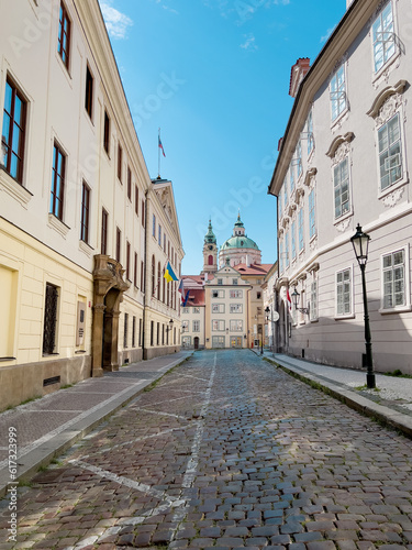 Narrow Alley in Prague with St. Nicholas Church in the background