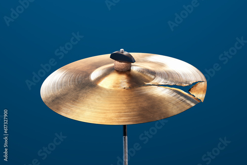 Shiny hand made drum plate is damaged. Closeup of broken cymbal for drums.