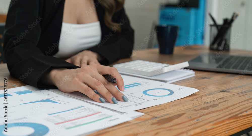 Close up of businesswoman hands using a calculator to check company finances and earnings and budget. Business woman calculating monthly expenses, managing budget, papers, loan documents, invoices Close up of businesswoman hands using a calculator to check company finances and earnings and budget. Business woman calculating monthly expenses, managing budget, papers, loan documents, invoices