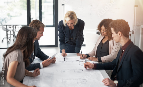 Business people, architect and blueprint in meeting, planning or team brainstorming on table at office. Group of contract engineers in teamwork, floor plan or documents for industrial architecture