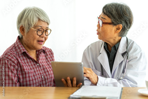 Asian senior doctor wearing uniform with stethoscope help discussing and consulting talk to sick senior patient checkup information, support, care, diseases, treatment in hospital.elderly healthcare