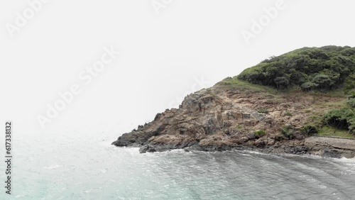 The Rocky cliff At Seashore near Orson Hotel And Resort In Con Dao, Vietnam. Aerial Drone jib Shot photo