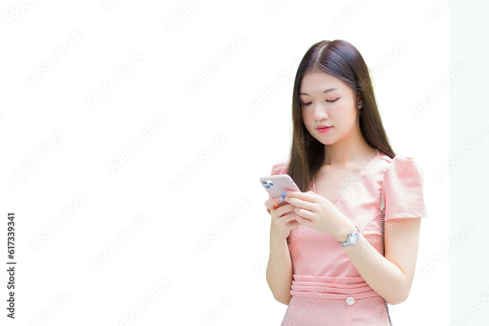 Young Asian professional business woman with long hair is smiling while looking at the smartphone in her hand, work from anywhere concept isolated on white background. Young Asian professional business woman with long hair is smiling while looking at the smartphone in her hand, work from anywhere concept isolated on white background.