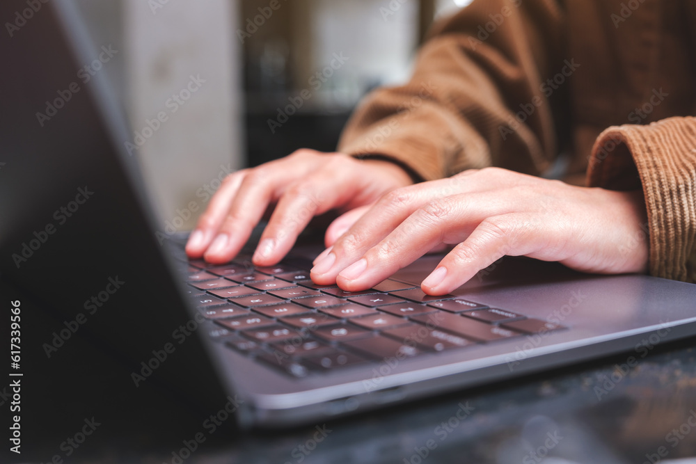 Closeup image of a woman working and typing on laptop computer keyboard Closeup image of a woman working and typing on laptop computer keyboard