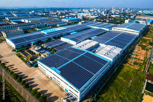 Aerial photography of solar photovoltaic panels built on the roof of a factory building