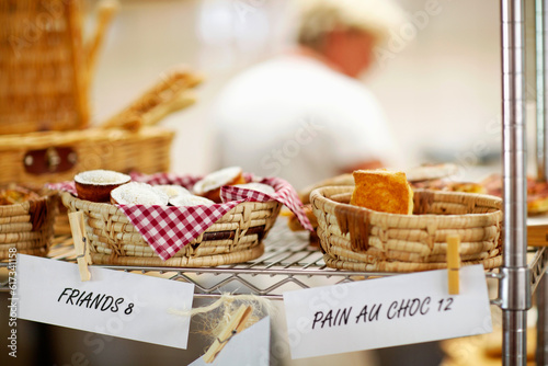 Bakery, window and shop with pricing of dessert, cake or food in cafe with advertising, product and store presentation. Sugar, goods and baked pastry, treats or muffin in a basket or small business