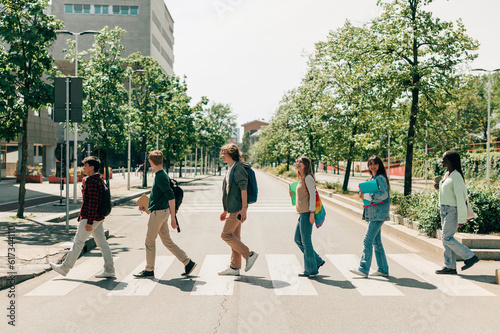Canvastavla students in single file cross the street on pedestrian crossings as in abbey roa