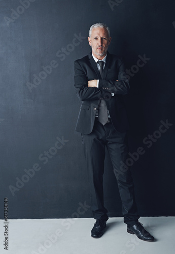 Portrait, serious and confident businessman with arms crossed in pride, lawyer or attorney on dark background. Boss, ceo and professional business owner, proud senior executive director at law firm.
