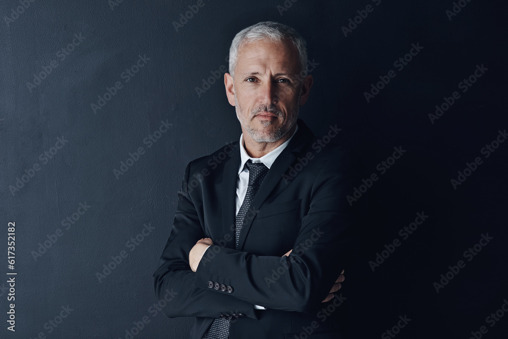 Senior executive, business man and arms crossed with confidence in portrait and management on dark background. Male CEO, corporate director and suit with ambition, empowerment and career in studio