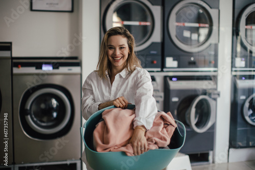 Slika na platnu Young woman posing in a laundry room.