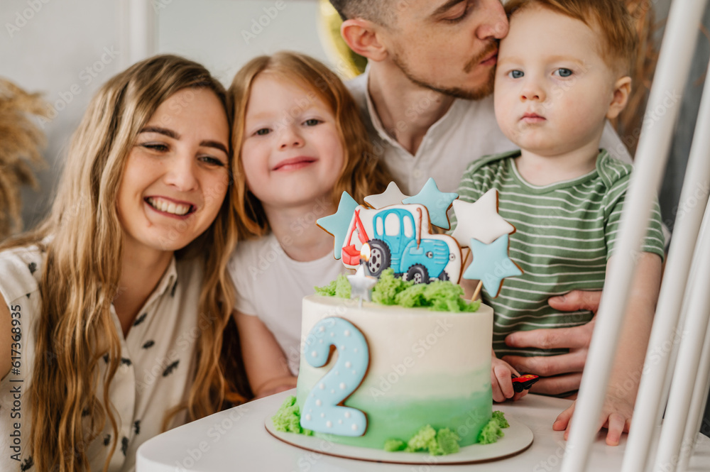 Cake. Happy family having fun celebrating a birthday party 2 years old ...