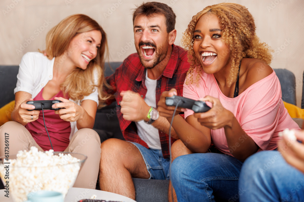 Fototapeta premium Friends playing video games and having fun at home