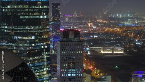 Wallpaper Mural Aerial view of traffic on Al Saada street in financial district night timelapse in Dubai, UAE. Illuminated skyscrapers and glowing windows in office towers from above. Deira on a background Torontodigital.ca