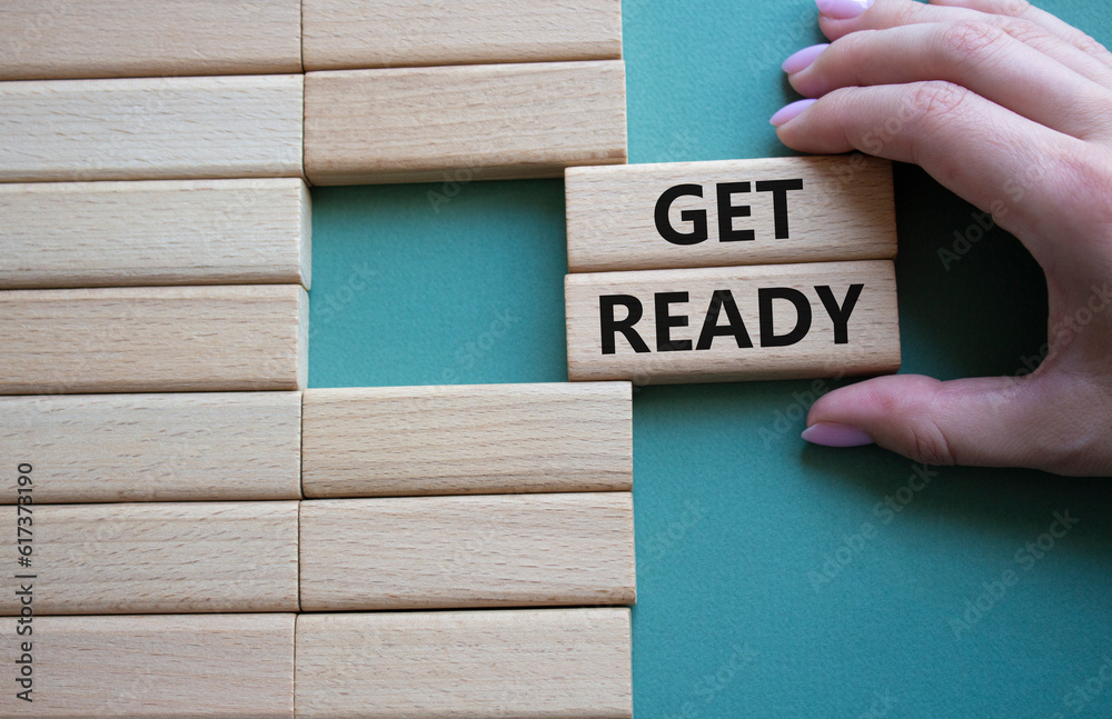 Get ready symbol. Wooden blocks with words Get ready. Beautiful grey green background. Businessman hand. Business and Get ready concept. Copy space. Get ready symbol. Wooden blocks with words Get ready. Beautiful grey green background. Businessman hand. Business and Get ready concept. Copy space.