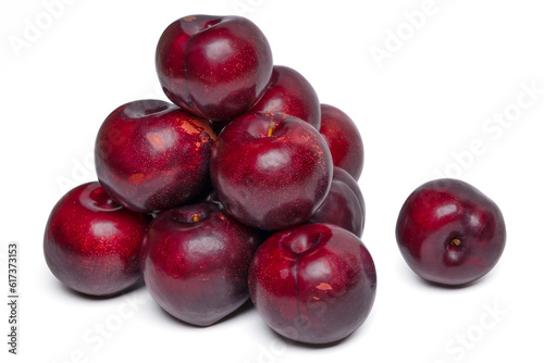 Fresh red plums fruit on white background.