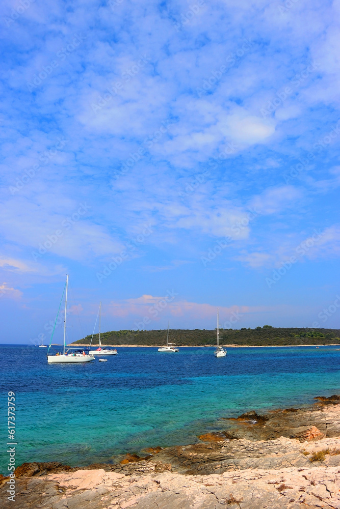 Beautiful wild beach and sailing boats on Proizd, small island near island Korcula, Croatia.