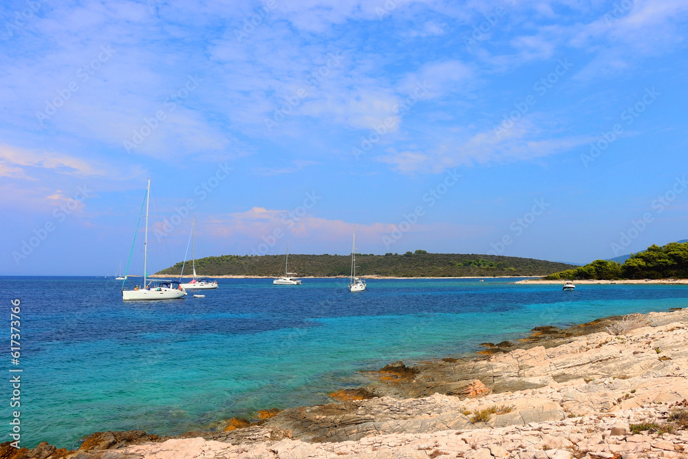 Fototapeta premium Beautiful wild beach and sailing boats on Proizd, small island near island Korcula, Croatia.