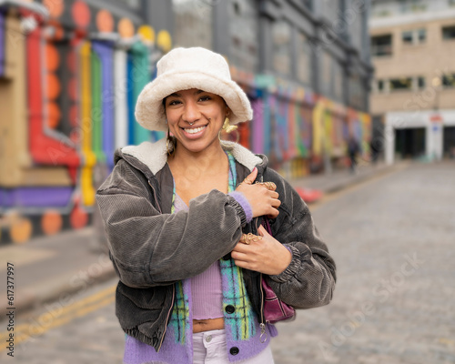 Portrait of smiling woman standing on city street