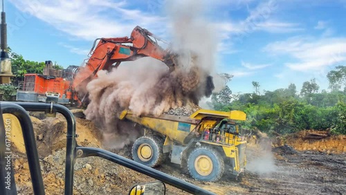 The dusty materials are transported by the mining truck, while the diligent excavator tirelessly delves into the depths of the earth's layers