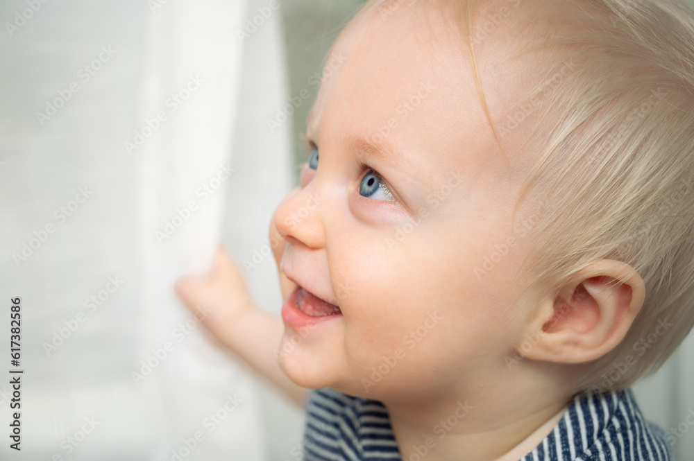 Cute baby with blue eyes - closeup portrait. Little boy at home looking away. Cute baby with blue eyes - closeup portrait. Little boy at home looking away.