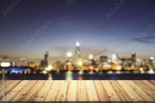 Wooden table top with beautiful blurry skyline at night on background  mockup