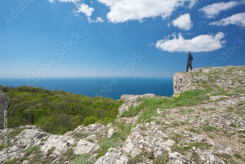 Man on sea cliff edge.