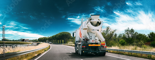Fotografie panorama Panoramic View Special Concrete Transport Truck In-transit Mixer Unit In Motion On Country Road, Freeway