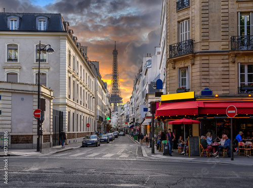 Fototapeta Naklejka Na Ścianę i Meble -  Cozy street with tables of cafe and Eiffel Tower in Paris, France. Architecture and landmark of Paris. Cozy Paris cityscape.