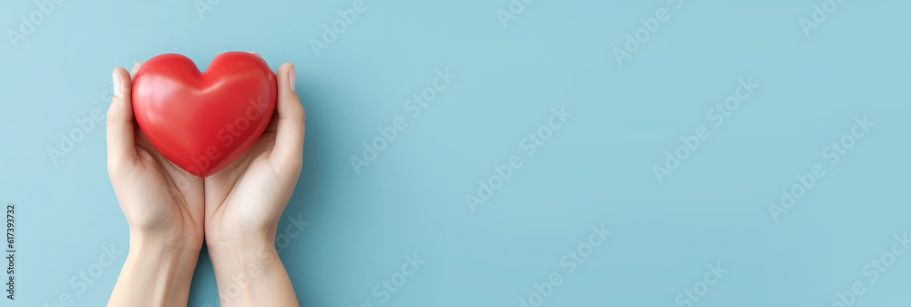 Red heart in man's hands isolated on blue background. Healthcare and hospital medical concept. Symbolic of Valentine day.Top view with space for text. Banner.Generative AI