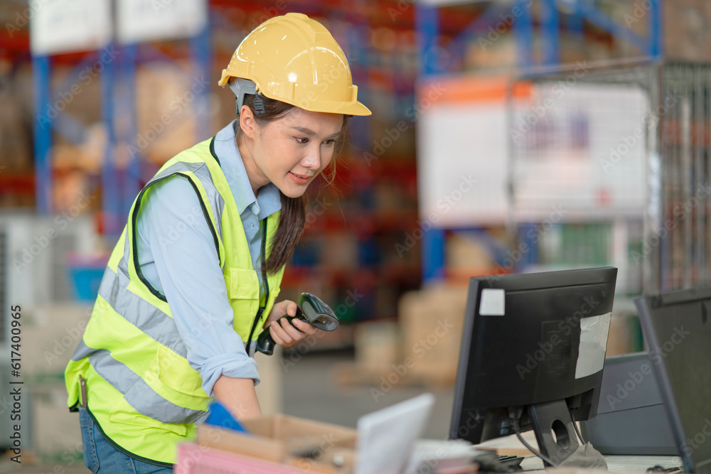 A female manager is checking inventory inside a warehouse. A female manager is checking inventory inside a warehouse.