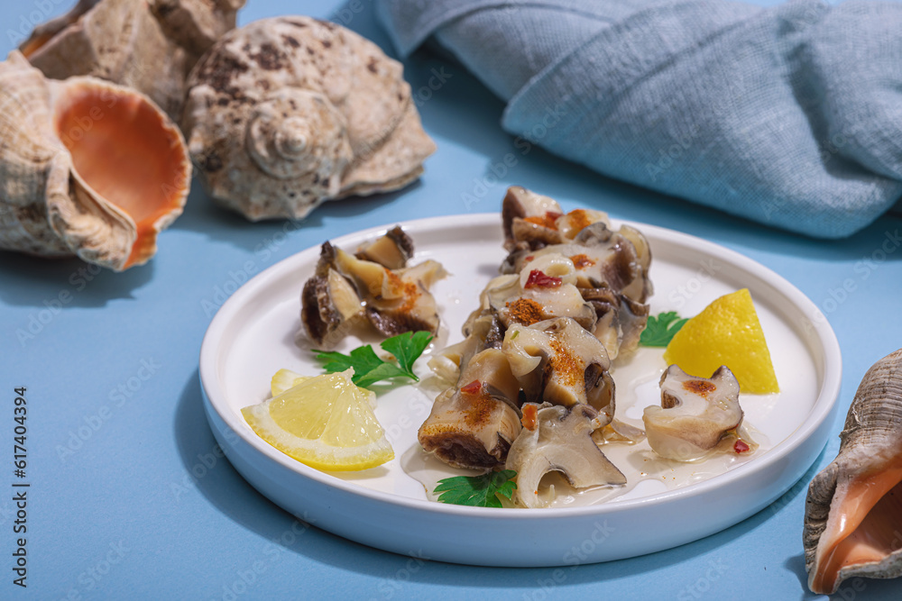 Pickled rapan meat with oil, spices and greens. Healthy seafood rich of omega Pickled rapan meat with oil, spices and greens. Healthy seafood rich of omega