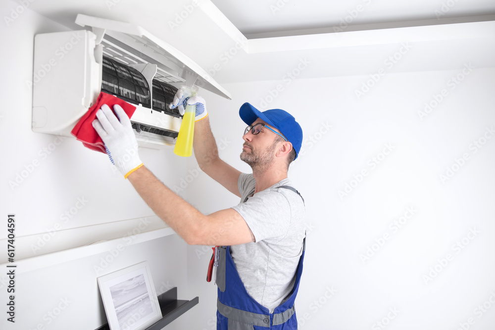 Service guy cleaning and maintaining air condition unit. Service guy cleaning and maintaining air condition unit.