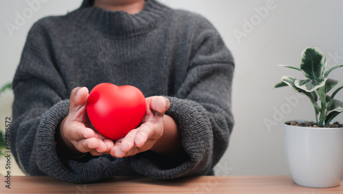 Good health and insurance concept  health insurance concept. Boy hand holding plus sign and red heart  positive volume.