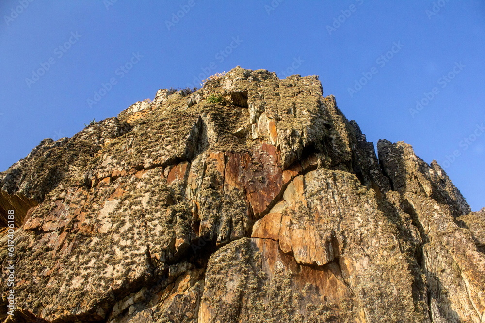 Ancient rugged rocks in sunlight and blue sky in North Wales Ancient rugged rocks in sunlight and blue sky in North Wales