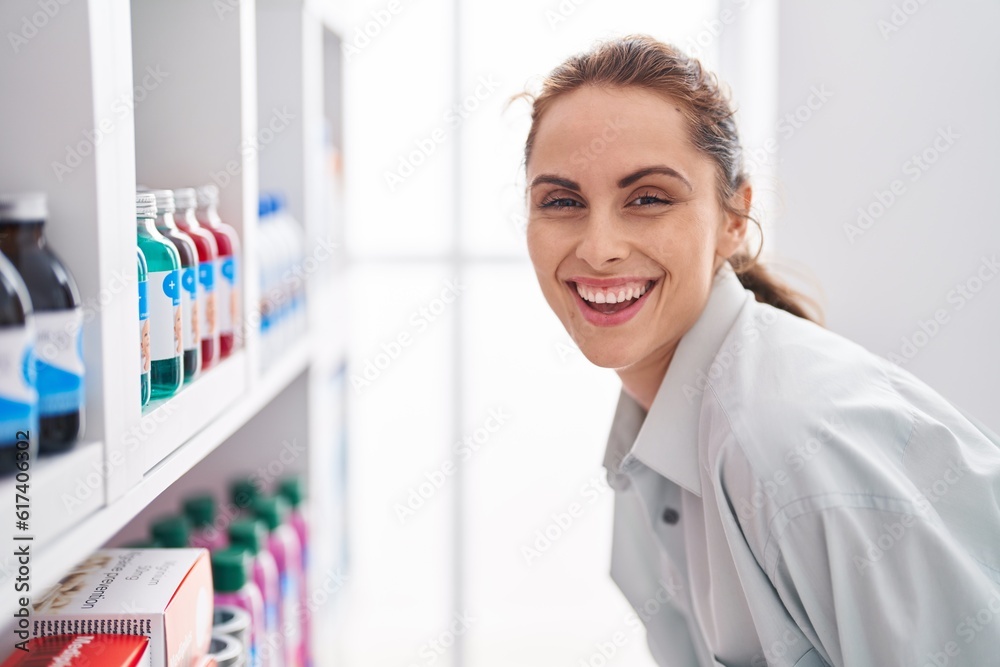 Young woman customer smiling confident standing at pharmacy
