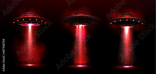 Valokuva Realistic set of UFOs with red light and smoke portals isolated on black background