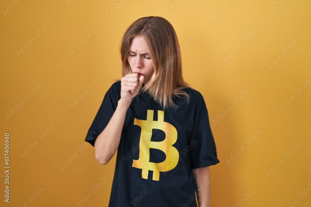 Blonde caucasian woman wearing bitcoin t shirt feeling unwell and coughing as symptom for cold or bronchitis. health care concept. Blonde caucasian woman wearing bitcoin t shirt feeling unwell and coughing as symptom for cold or bronchitis. health care concept.