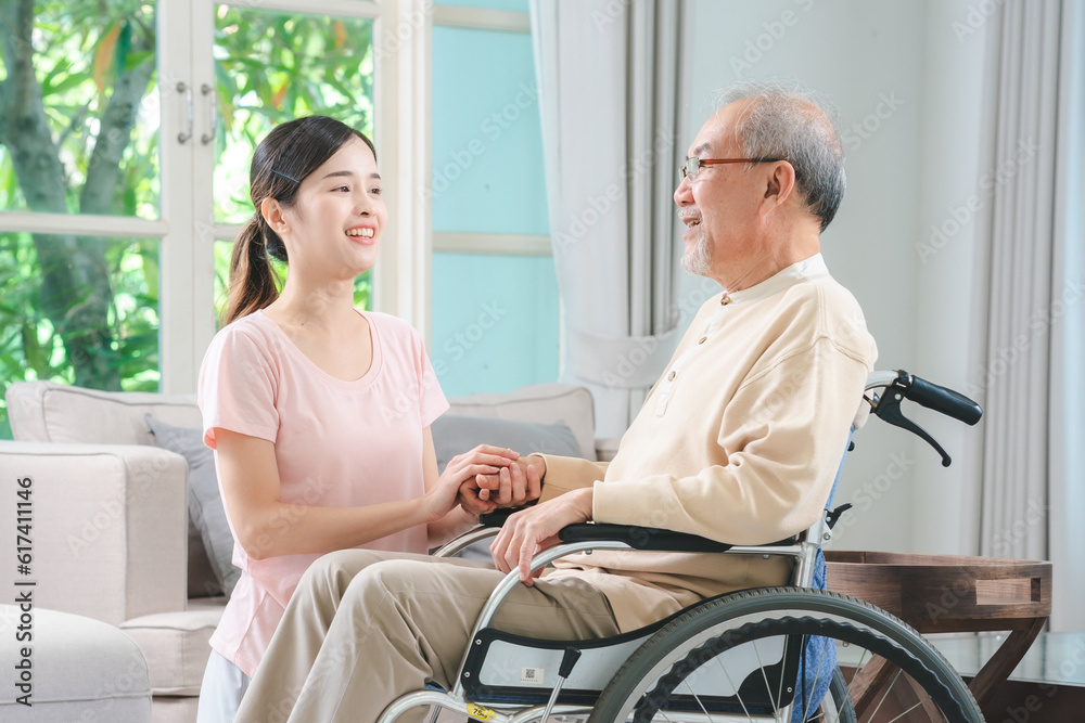 Asian family health care and insurance business at home concept, woman daughter take care support to senior elderly father patient in wheelchair together, dad having smile in happy love lifestyle