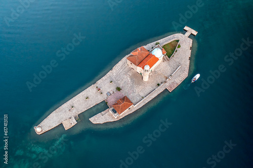 Aerial top view of the island Our Lady of the Rocks near the picturesque town of Perast in the waters of the Bay of Kotor, Montenegro. © Jess_Ivanova