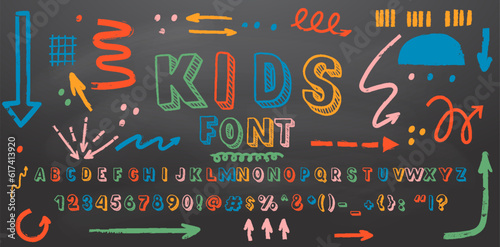 Colorful retro hand drawn alphabet letters drawing with chalk on black chalkboard