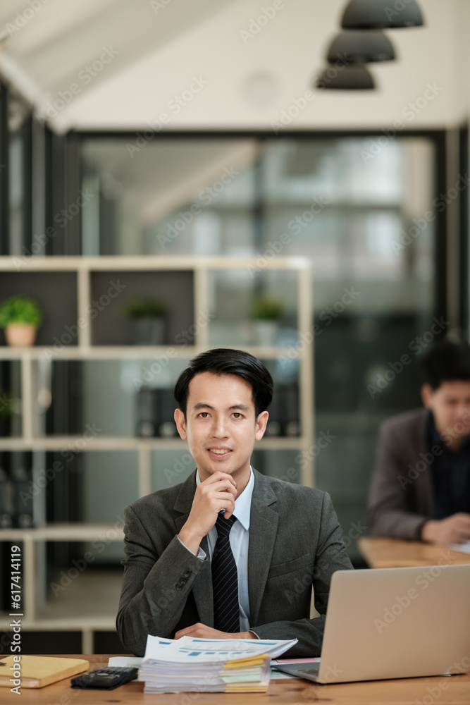 Handsome cheerful asian man executive business man at the workspace office Handsome cheerful asian man executive business man at the workspace office