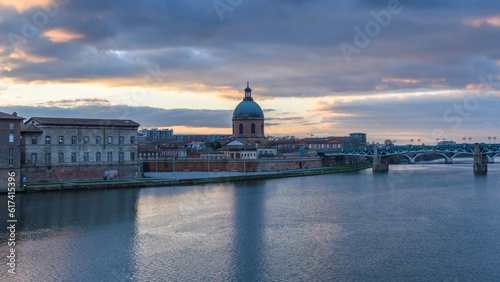 View across the Garonne river to The Hôpital de La Grave hospital, with a dome and bell tower. photo