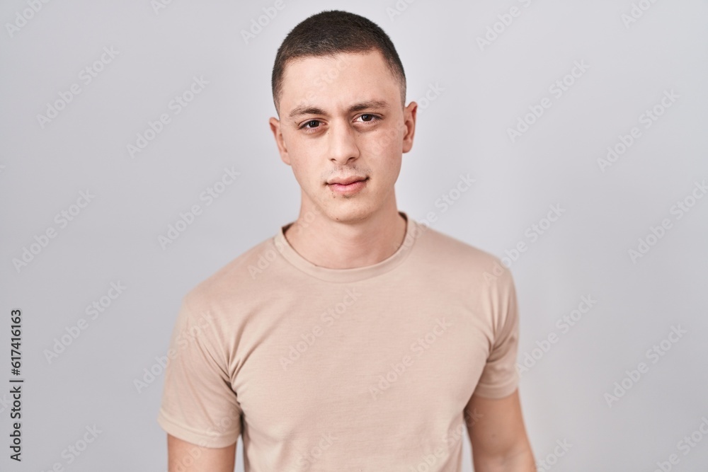 Young man standing over isolated background skeptic and nervous, frowning upset because of problem. negative person. Young man standing over isolated background skeptic and nervous, frowning upset because of problem. negative person.