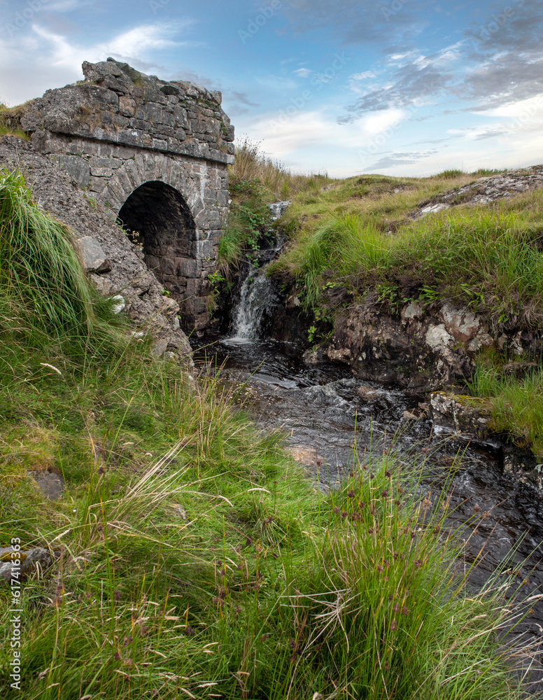 Westcoast Ireland. Conemara. Peat and heather fields. Foggy. Stone bridge and small stream.